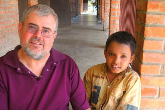 Richard Waller is pictured with a young patient at the hospital.