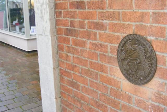 The Wyvern motif of local architects Kirk and Parry features in the plaque on Sleaford Museum. EMN-170901-133806001