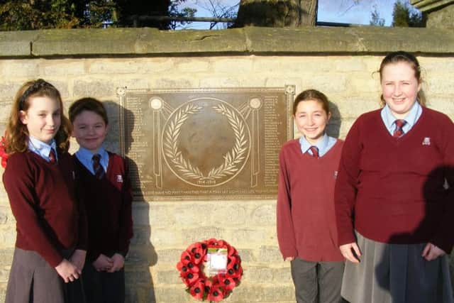 The plaque in memory of William Alvey School's 72 fallen war heroes has been installed. Pictured with it are members of the school's Bluey Club for children from RAF families. From left - Grace Gordon, Casper Jackson, Erin Clifford and Chloe Scrafton. EMN-170501-173437001