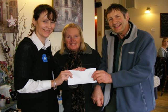 Emma Massey, owner of Blanchards coffee shop presents ?400 to Jane and John Maddison of Sleaford Dementia Support. EMN-170501-154012001