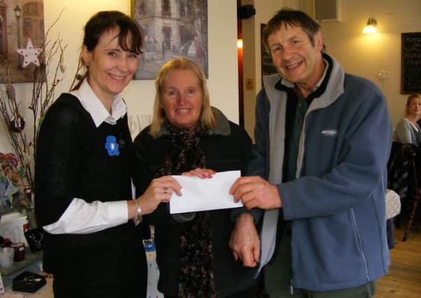 Emma Massey, owner of Blanchards coffee shop presents ?400 to Jane and John Maddison of Sleaford Dementia Support. EMN-170501-154012001