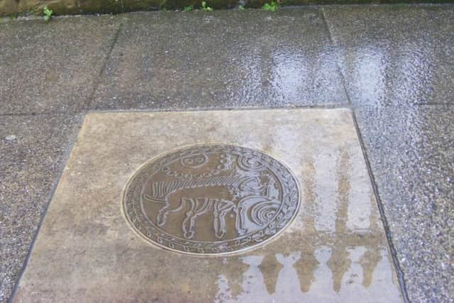 An image of a Corieltauvi coin, referring to the iron age mint found in Old Sleaford, which is sunk into the pavement on Southgate. EMN-170901-133755001