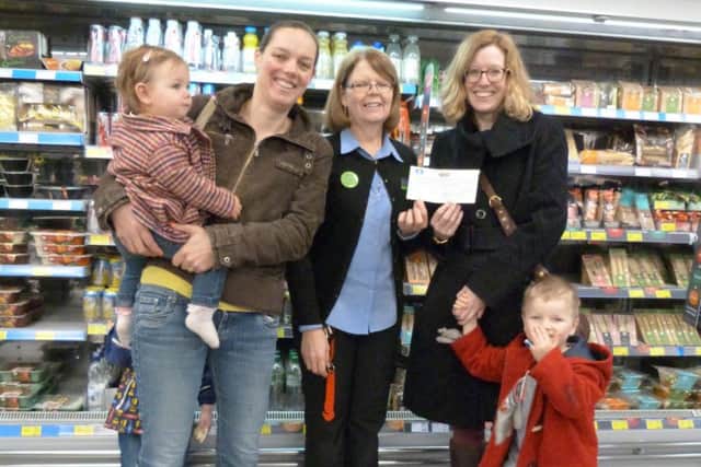 Emma Dix, right, and Freddie receiving the cheque from Debbie McKitton with Rachel Pettifer, Anna (1) and Oustin (3) at Caistor Co-op EMN-171001-162745001