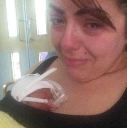 Anxious mum Danielle Stoakes nurses tiny baby Reggie. ANL-170901-165044001