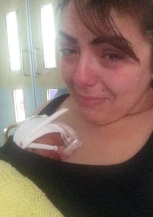 Anxious mum Danielle Stoakes nurses tiny baby Reggie. ANL-170901-165044001