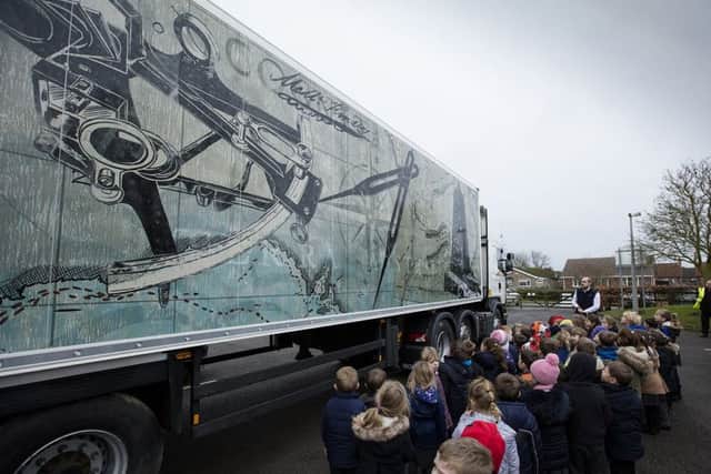 Pupils at Swineshead St Mary's CofE Primary School inspect one of the 10 Fenland Folk lorries.