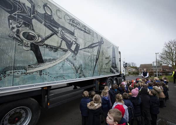 Pupils at Swineshead St Mary's CofE Primary School inspect one of the 10 Fenland Folk lorries.