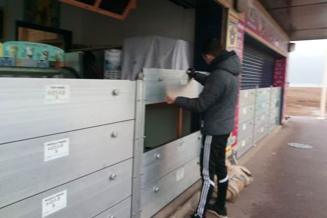 Ryan Speedy at his kiosk preparing for possible flooding in Skegness. ANL-171201-142933001
