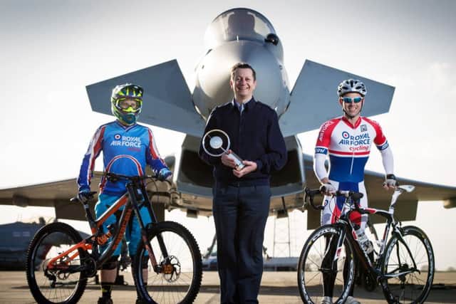 Deputy OIC Chief Technician John Eaton holding the Keith Roland-Holmes Trophy, with SAC(T) Paul Rogers and Cpl Gary Sparkes, members of the cycling club. Photo: Crown Copyright. CON-OFFICIAL-