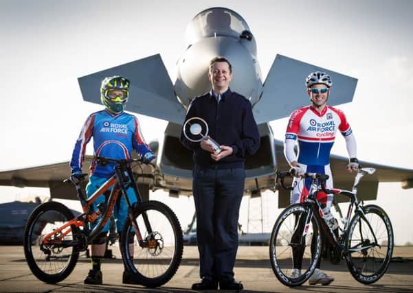 Deputy OIC Chief Technician John Eaton holding the Keith Roland-Holmes Trophy, with SAC(T) Paul Rogers and Cpl Gary Sparkes, members of the cycling club. Photo: Crown Copyright. CON-OFFICIAL-