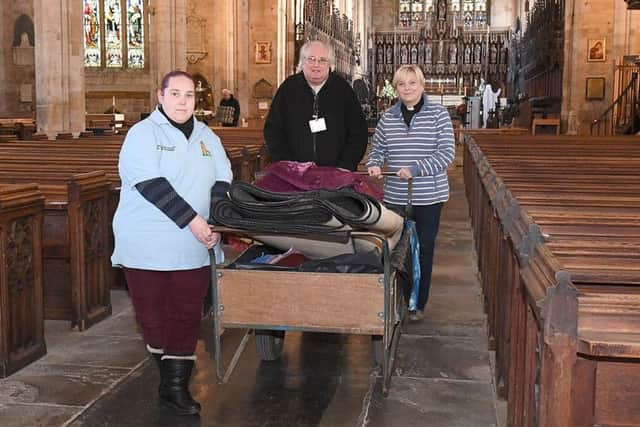 Boston Stump volunteers putting eveything back after preparing for potential tidal surge flood. L-R Kerry Bateman, John Knight and Rev Alyson Buxton.