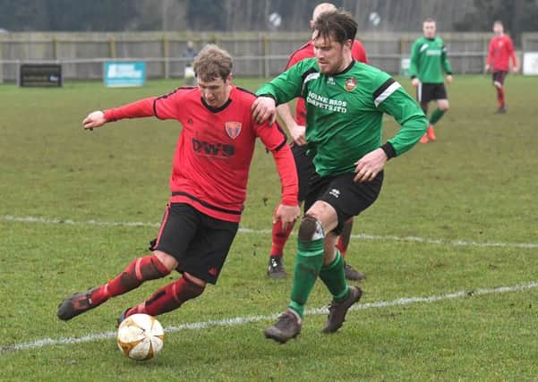Sleaford Town Res (green) v Sleaford Sports Amateurs FC (red). Luke Hollingworth (green), David Cook (red). EMN-170123-175932002