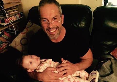 Brad Olsen with little Olivia. EMN-170119-173744001
