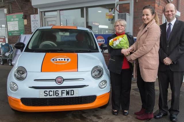 Wheels of fortune: Lynne Wells with Eleanor Clayson and Scott Davies - and the new car.