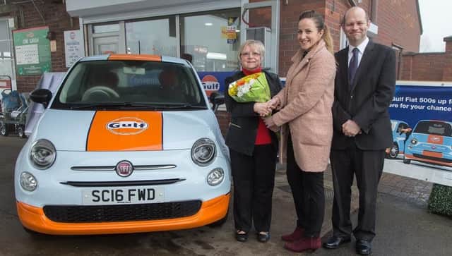 Wheels of fortune: Lynne Wells with Eleanor Clayson and Scott Davies  -  and the new car.