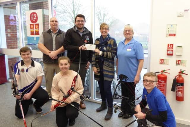 Pictured are store manager Ben Pickwell and shop assistant Marion Woodward from the Old Leake Co-op, with club chairman Mark Edwards, club secretary Sarah White and junior archers Sam Edwards, Jessica White and Jamie White.