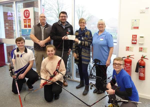 Pictured are store manager Ben Pickwell and shop assistant Marion Woodward from the Old Leake Co-op, with club chairman Mark Edwards, club secretary Sarah White and junior archers Sam Edwards, Jessica White and Jamie White.