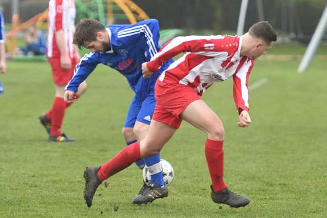 Swineshead Reserves' Rhys Holland and George Swift, of Horncastle Town Reserves, clash for the ball.