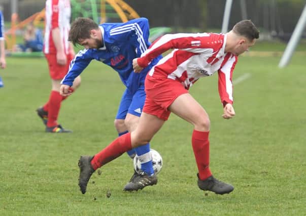 Swineshead Reserves' Rhys Holland and George Swift, of Horncastle Town Reserves, clash for the ball.