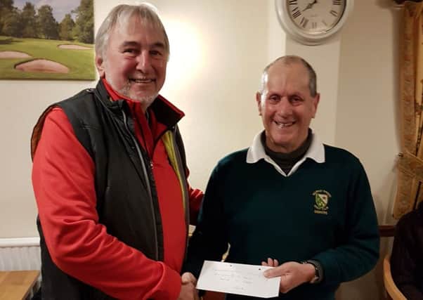 Chris Brooke receives his prize from seniors club secretary Nick Robey EMN-170123-162224002