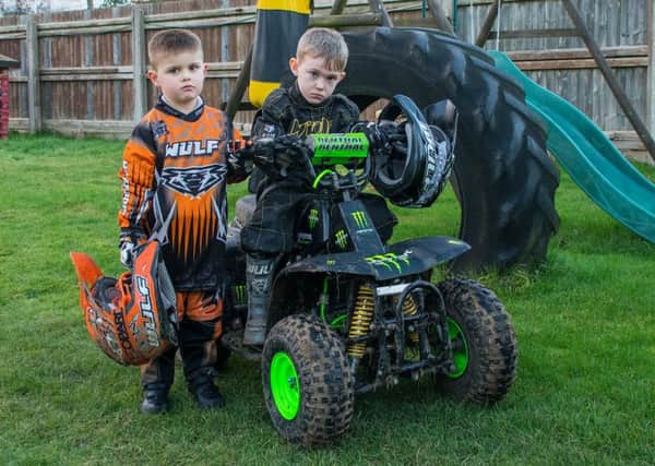Levi, four,(left) and Elliott, five, are disappointed they have no place to ride their quad bikes.