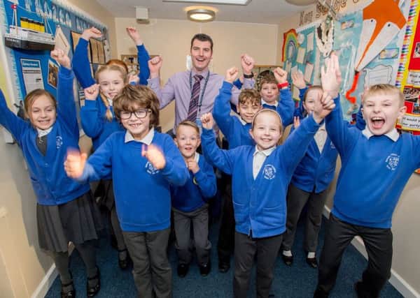 Spilsby Primary School headteacher Andrew Clarke celebrating with pupils. Photo: John Aron ANL-170124-102142001