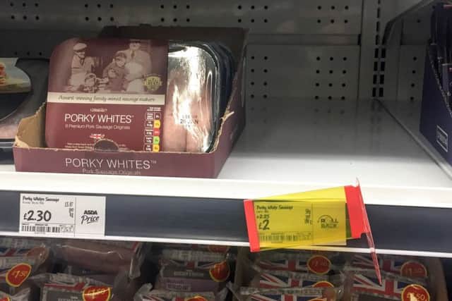 A empty shelf of sold out Porkt Lights sausages in an ASDA