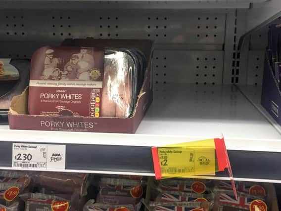 A empty shelf of sold out Porkt Lights sausages in an ASDA