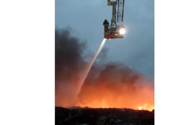 A hellish scene as the aerial platform sprays the blazing bales at Barkston Heath near Ancaster back in 2015. Photo: Phillip Grimes EMN-170124-174834001