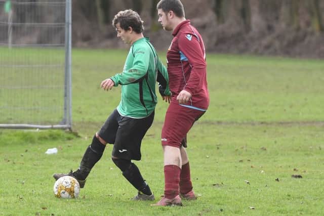 FC Hammers (red) v Fulbeck United (green). Richard Hardy (red), Paul Crampton (green). EMN-170130-175116002