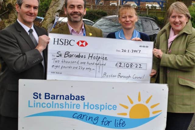 Martin Potts, Boston Borough Councils principal officer Bereavement, left, and Coun Claire Rylott, the councils cabinet member with responsibility for crematoria and cemeteries, right, present the cheque to Chris Wheyway, chief executive St Barnabas Lincolnshire, and staff nurse Sue Thurston.Photo supplied.
