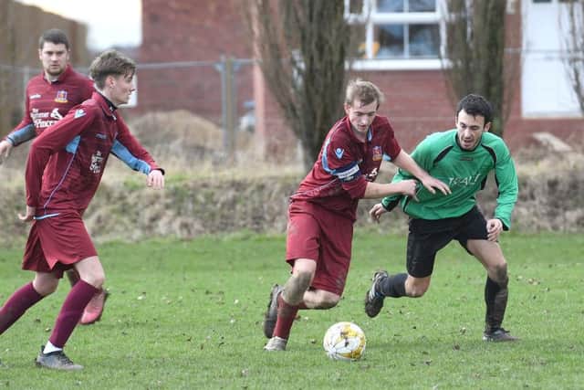 Kristian Taylor battles with Will Allen in FC Hammers' 4-1 defeat to Fulbeck.