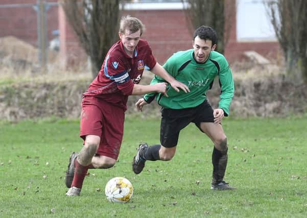 Kristian Taylor battles with Will Allen in FC Hammers' 4-1 defeat to Fulbeck.