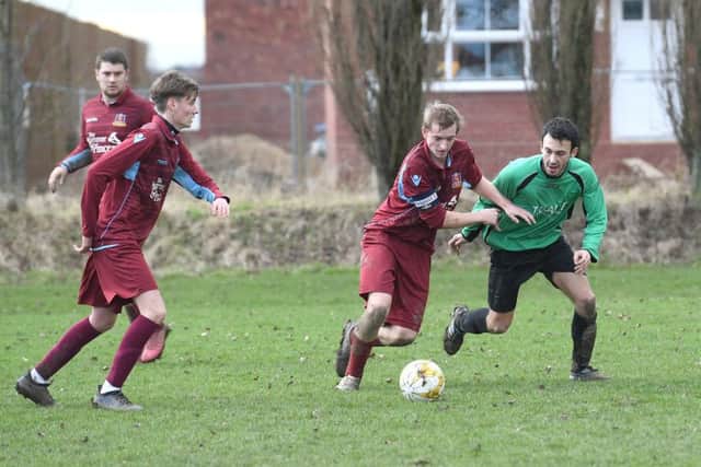 Kristian Taylor battles with Will Allen in FC Hammers' 4-1 defeat to Fulbeck.