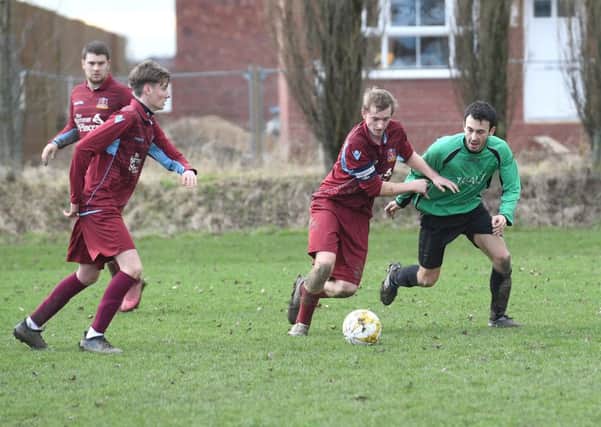 Kristian Taylor battles with Will Allen in FC Hammers' 4-1 defeat to Fulbeck.