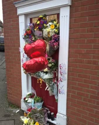 Floral tributes left at the door of Richard Madges home after his sudden death.
