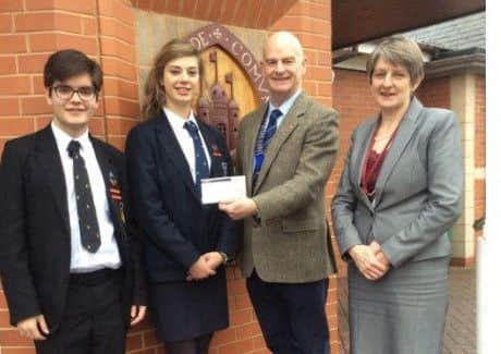 Lion President Steve Flood handed a cheque for ?500 to Mrs Payne, Head Teacher at QEGS, accompanied by Phoebe Merritt Head Girl and Gui Freitas Head Boy. EMN-170802-093217001
