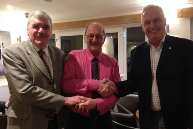 Lion Terry Box (left) and Lion President Peter Morris (right) presented Malcolm Bolton with a donation of ?500. (Photo by Linda Oxley) EMN-170702-150119001