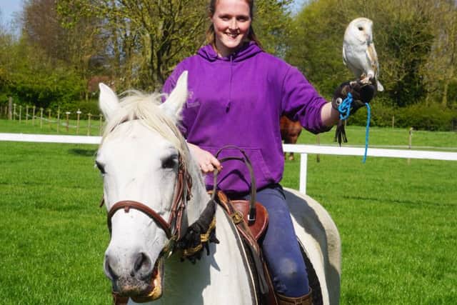 Izzy, who has been volunteering at the Centre for 14 years, riding Pluto the horse and holding Fal the owl. EMN-171002-143536001