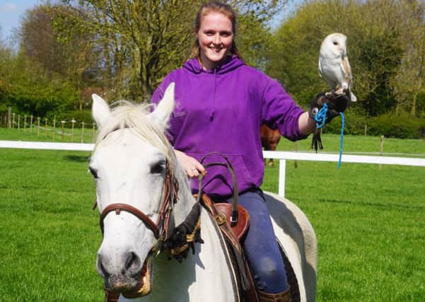 Izzy, who has been volunteering at the Centre for 14 years, riding Pluto the horse and holding Fal the owl. EMN-171002-143536001
