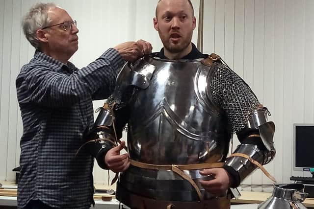 Richard Brighton gets kitted out in his armour with the help of dad Terry EMN-170602-102932001