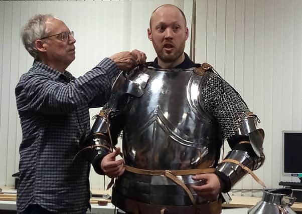 Richard Brighton gets kitted out in his armour with the help of dad Terry EMN-170602-102932001
