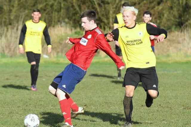 Chris Robinson holds up the ball for Ruskington in their 4-1 defeat at Wyberton Reserves on Saturday. EMN-170702-102653002