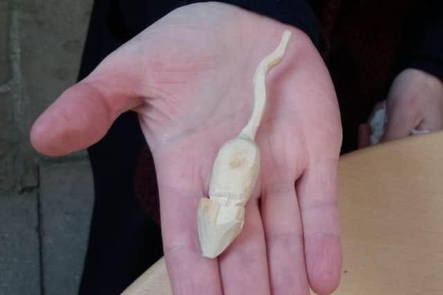 Stump volunteer Lisa Taylor holding one a wooden mouse found in the church. EMN-170802-123349001
