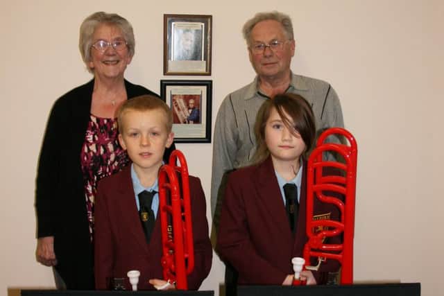 Manfred and Shirley James with Maisie Allen and Sean Briggs with two lightweight plastic trombones. ANL-170217-111231001