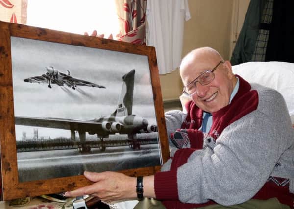 Reuben Kirk, with his prized possession of a pencil drawing of an Avro Vulcan aircraft.