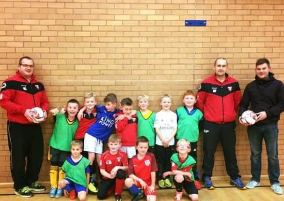 Louth OB Under 8s with Wez Smith, company director of WI Smith Building Services who supplied futsal balls for their winter indoor training EMN-170902-173020002