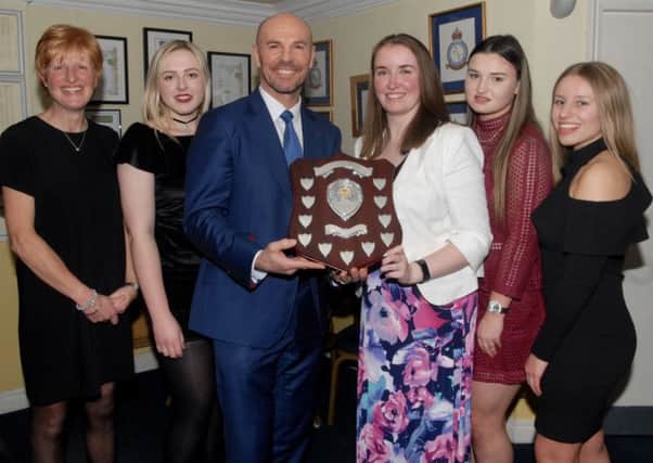 Market Rasen ladies' captain Bethany Smith receives the award from Paul Nixon, flanked by, from left, Catherine Fussey, Rebecca Brooker, Amy Halloran and Niamh Skipworth. EMN-170213-164139002