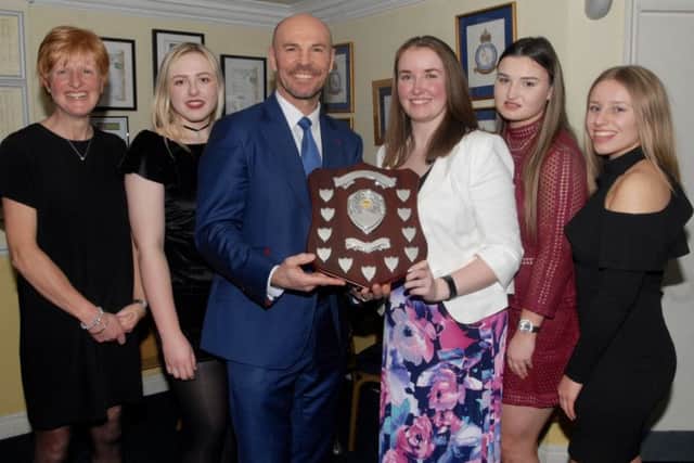 Market Rasen ladies' captain Bethany Smith receives the award from Paul Nixon, flanked by, from left, Catherine Fussey, Rebecca Brooker, Amy Halloran and Niamh Skipworth. EMN-170213-164139002