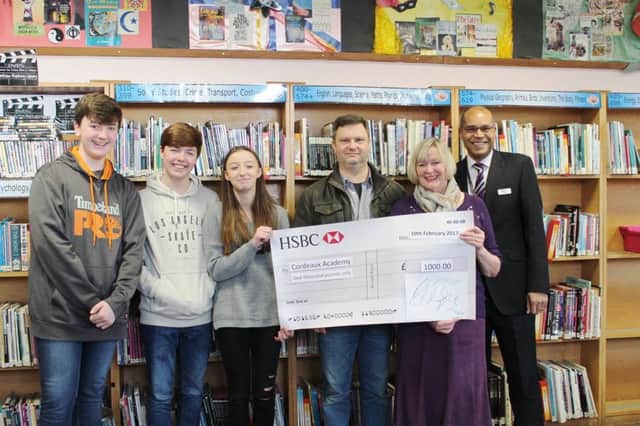 Pantomime representatives present the cheque to Cordeaux Academy.